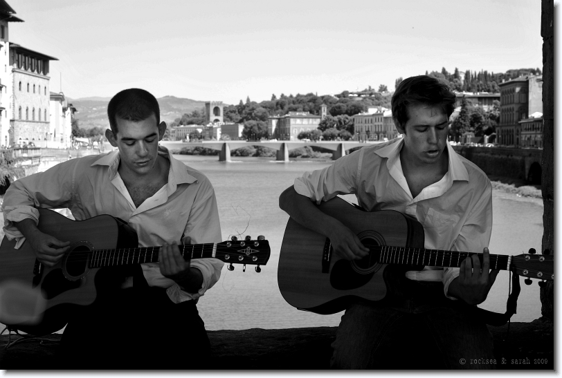 Playing Guitars at the bridge on River Arno in Florence, Italy